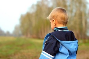 embarrassed boy with back to camera