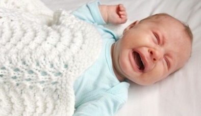 crying-baby-in-crib-suffering-from-colic