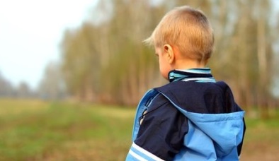 Embarrassed boy with back to camera